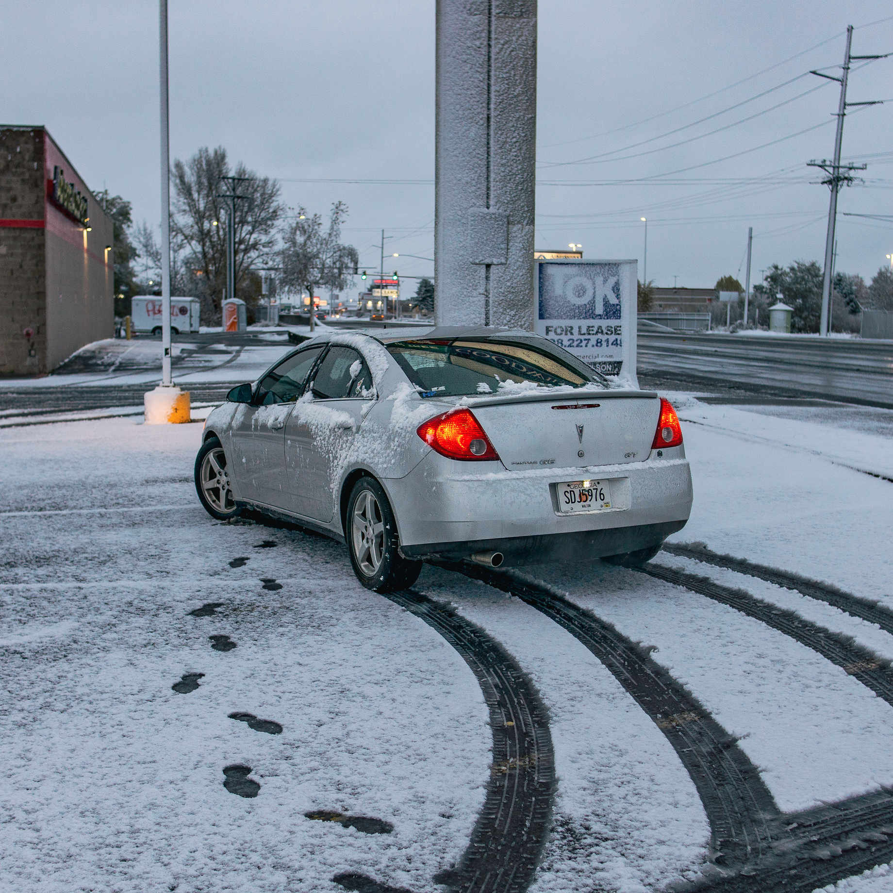 Silver Sedan Covered in Snow
